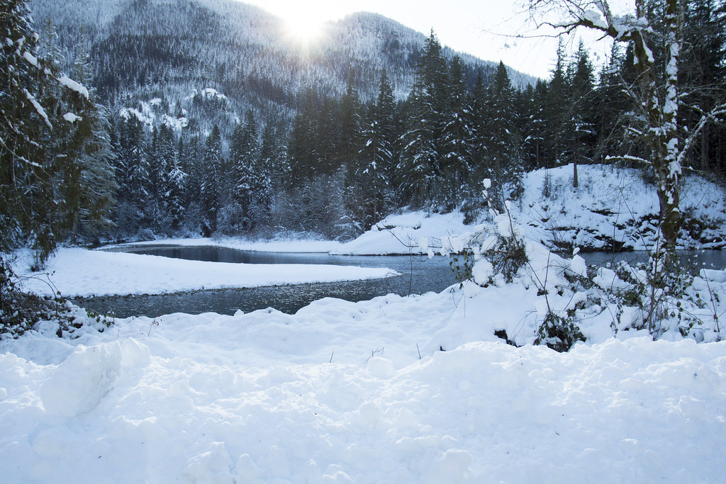Snow-covered river and wooded hills at Beaulieu Camp